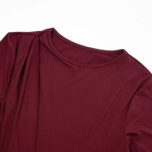 Detail of the crew neck and pleated shoulder design on a wine red knit dress