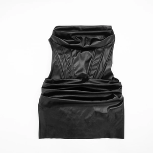 Detail of black faux leather dress showing bone corset structure and pleating textures