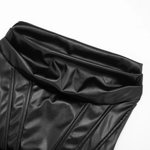 Detailed close-up of pleated PU leather fabric and stitching on a black tube dress