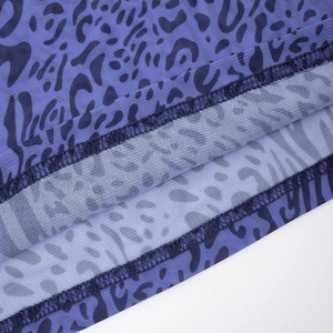 Macro view of purple leopard mesh fabric showing precise double-needle hem stitching