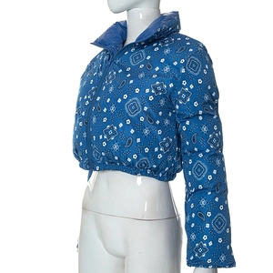 Detail of royal blue paisley print and zipper closure on reversible padded jacket