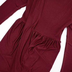 Detailed view of burgundy maxi dress featuring elegant pleats and soft knitted fabric texture