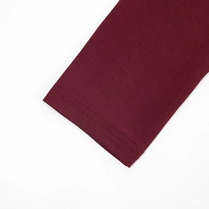 Detail view of burgundy long sleeve cuff with high-density knit and double-needle stitching