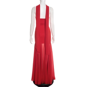 Detail of elegant red maxi dress featuring backless design and long chiffon streamers