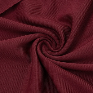 Close-up of elegant dark red fine ribbed knit fabric with smooth draped texture
