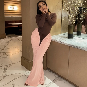 Detail of the elegant pleated pink maxi skirt with V-shaped waist and slim fit design