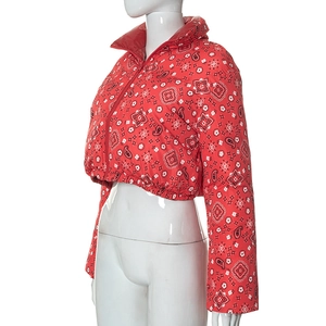 Close-up of red paisley print on women's padded jacket with stand-up collar and zipper