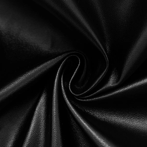 Detailed macro view of the black PU leather fabric showing fine litchi texture and soft matte finish