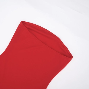 Detailed close-up of red knit fabric featuring clean double-needle stitching and texture