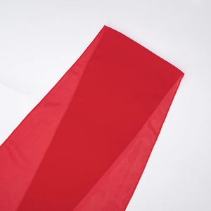 Detail of red chiffon dress fabric showing soft texture and translucent draping