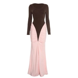 Detail view of the brown long sleeve top and pink pleated waist on the elegant maxi dress