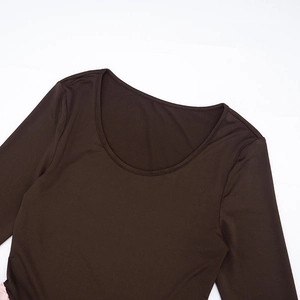 Detailed view of the wide round neckline and fine stitching on dark brown knit dress