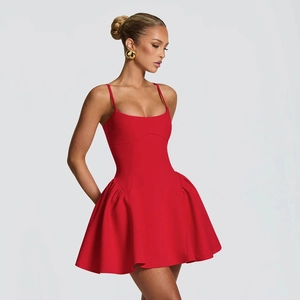 Detail of red sleeveless mini dress featuring side pleats and a structured A-line skirt