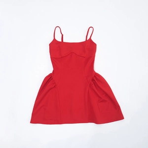 Detail of red camisole dress showing adjustable straps and pleated skirt texture