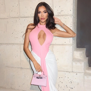 Detail of pink halter neck cutout top and white pleated long skirt with matching streamer