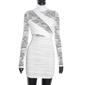 Detail of white bodycon dress featuring sheer lace sleeves and ruched mini skirt design
