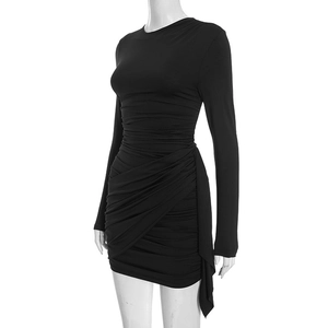 Detail view of the side ruched textures and slim fit wrap hem on this black mini dress