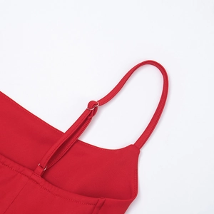 Detail of red dress with adjustable thin shoulder straps and silver metal buckles