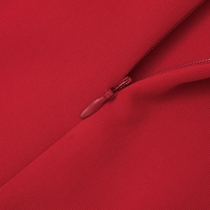 Close-up of high-quality red knitted fabric featuring a seamless matching hidden zipper detail