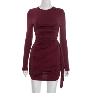 Detailed view of wine red bodycon mini dress with ruched fabric and asymmetrical hem