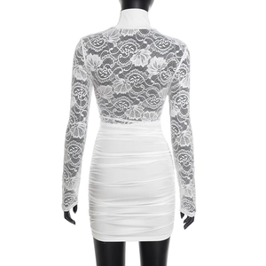Detail of white bodycon dress featuring sheer floral lace sleeves and a ruched skirt