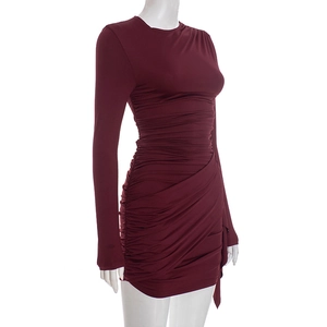 Detail of ruched burgundy bodycon dress featuring side pleats and irregular hem design