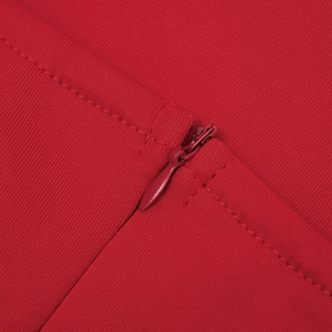 Macro view of seamless invisible zipper and professional stitching on red knit dress