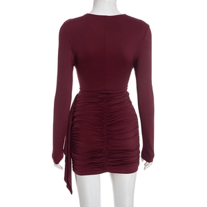 Detail view of burgundy long sleeve ruched mini dress with elegant side ribbon decoration