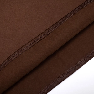 Detail view of brown square neck dress showing precise double-stitched hem and fabric texture