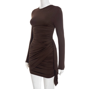 Detail of ruched texture and draped fabric on a slim-fit dark brown long sleeve dress