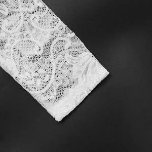 Close-up of intricate white floral lace pattern with delicate embroidery details