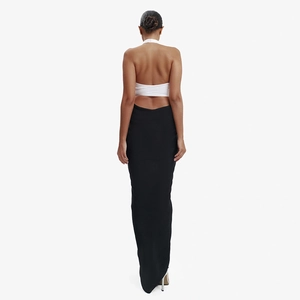 Detail of elegant backless halter neck design on a sleek black and white long dress