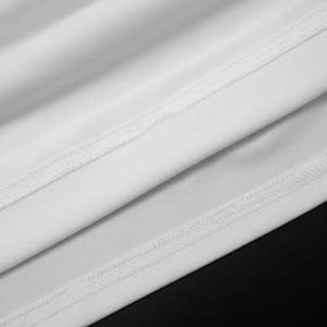 Detailed close-up of double-stitched seams and white knitted fabric texture on the dress
