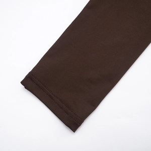 Detailed view of high-density chocolate brown knit fabric with precise double-needle stitching