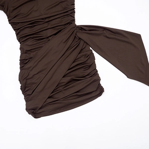 Detail of brown ruched mini dress showing elastic knit texture and side ribbon ties