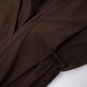 Macro detail of high-elasticity fabric with precise overlock stitching and refined seams