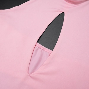 Close-up of pink knit dress detailing leaf-shaped cutout and refined edge stitching
