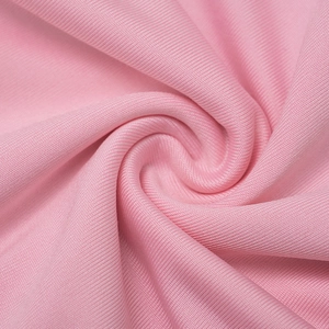 Detail of pink ribbed knit fabric showing soft texture and vertical striped pattern