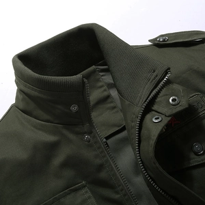 Detail of army green cotton jacket collar with shoulder epaulets and zip closure