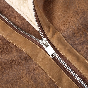 Detailed macro view of vintage brown faux leather jacket with warm cream fleece lining