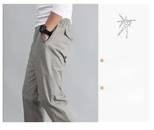 Detail view of men's casual cotton trousers featuring elastic waistband and side zip pockets