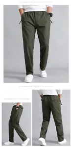 Detail of olive green cotton casual pants featuring elastic waist and zip pockets