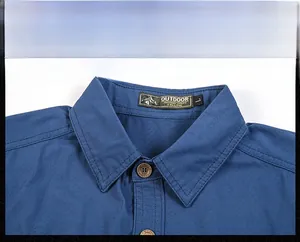 Detail of navy outdoor shirt collar featuring woven label and vintage style buttons