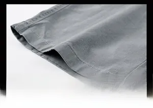 Detailed macro view of the stitching and cotton twill fabric on grey cargo shorts