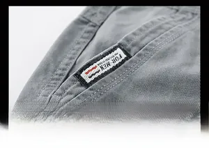 Detailed close-up of high-quality cotton twill fabric and premium woven logo patch