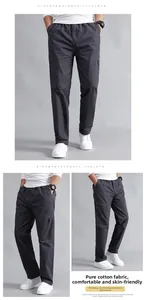 Detailed view of dark grey cotton cargo pants with drawstring waist and large pockets