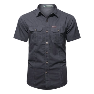 Detail of dark grey short sleeve outdoor shirt featuring twin flap pockets and topstitching