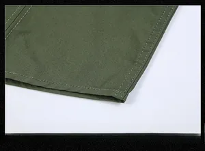 Close-up of army green shirt hem showing precise double-needle stitching and fabric texture