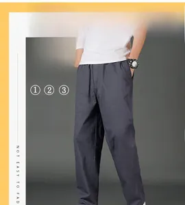 Detail of dark grey cotton cargo pants with straight leg fit and functional pockets