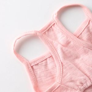 Close-up of pink pet dress showing textured cotton fabric and refined stitching detail